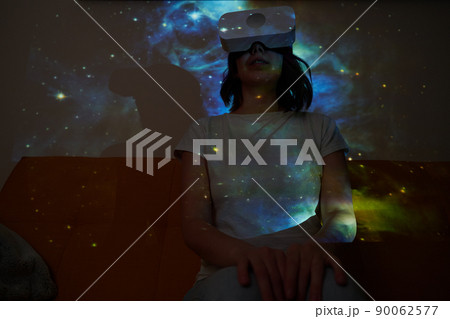 Woman uses virtual reality glasses to see the galaxy space. Elements of this image furnished by NASA. Woman uses virtual reality glasses to see the galaxy space. Elements of this image furnished by NASA. 90062577