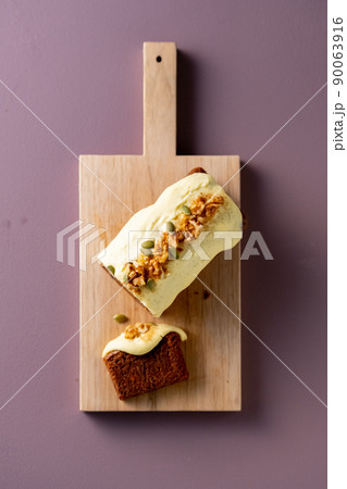 Sliced carrot cake on cutting board. 90063916