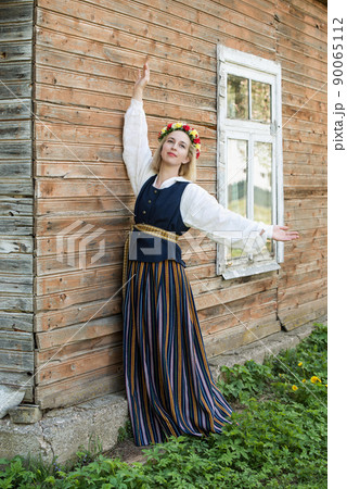 Woman in traditional clothing posing on nature in village. Woman in traditional clothing posing on nature in village. 90065112