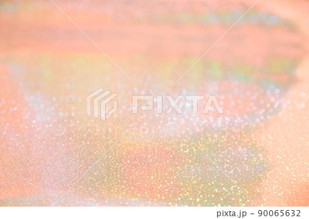 Holographic abstract shiny defocused background with bokeh in pastel orange tones of peach rose gold color Holographic abstract shiny defocused background with bokeh in pastel orange tones of peach rose gold color 90065632