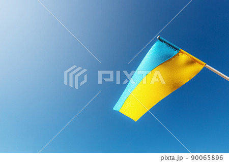 Large bicolor yellow blue Ukrainian state flag, national symbol fluttering, waving in wind against blue sky on sunny day. Kyiv city, capital of Ukraine, Independence Constitution Day, National holiday Large bicolor yellow blue Ukrainian state flag, national symbol fluttering, waving in wind against blue sky on sunny day. Kyiv city, capital of Ukraine, Independence Constitution Day, National holiday 90065896