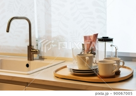 Clean utensils on wooden table near kitchen sink. Clean utensils on wooden table near kitchen sink. 90067005