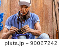 old afro american artisan working in wood sculptures 90067242