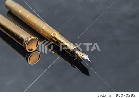 Fountain pen on a marble and gray background. Selective focus. Fountain pen on a marble and gray background. Selective focus. 90070595