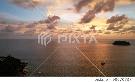 Luxury yacht at sunset with a view of the island. 90070737