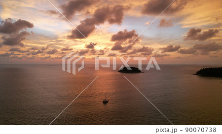 Luxury yacht at sunset with a view of the island. 90070738