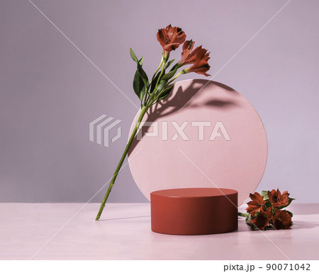 Red cylindrical podium, Cosmetic display stand with flowers on pink background 90071042