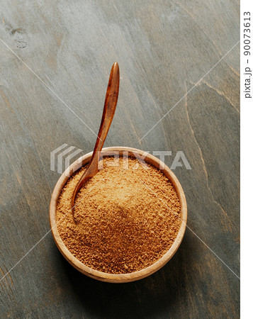 Bowl raw brown coconut sugar. Vertical. Copyspace 90073613