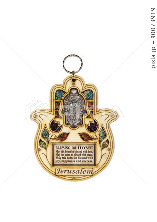 Wooden hamsa for blessing with colourful stones isolated on white background Wooden hamsa for blessing with colourful stones isolated on white background 90073919