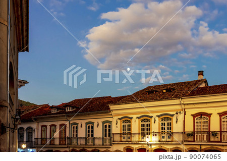 Facades of old colonial style houses with their balconies and windows 90074065