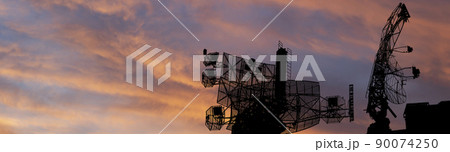 Air defense radars of military mobile anti aircraft systems, modern army industry on the background of the sunset orange sky, Russia Air defense radars of military mobile anti aircraft systems, modern army industry on the background of the sunset orange sky, Russia 90074250