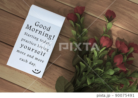 Motivational and inspirational quote written on a notepad on wooden background. 90075491
