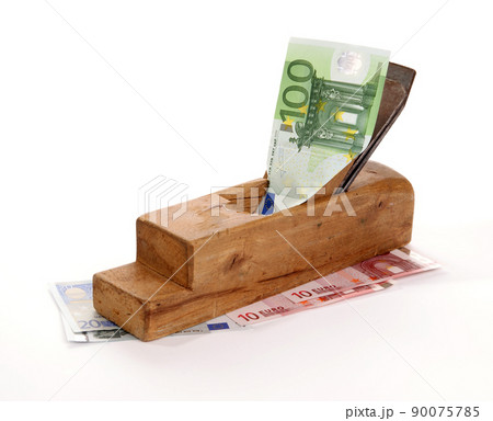 Work and earn. Old wood the planer and paper banknotes on a white background 90075785