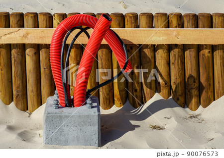 Concrete base of a new lighting lantern pole with screws and supply cable outlets Concrete base of a new lighting lantern pole with screws and supply cable outlets 90076573