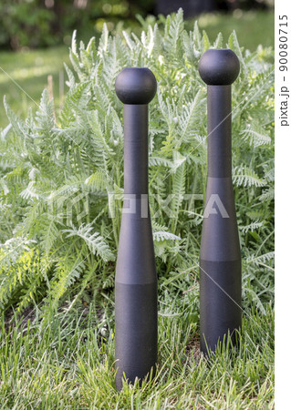 pair of heavy steel clubs in backyard pair of heavy steel clubs in backyard 90080715