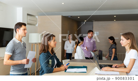 female lawyer sitting with laptop and consulting her clients 90083301