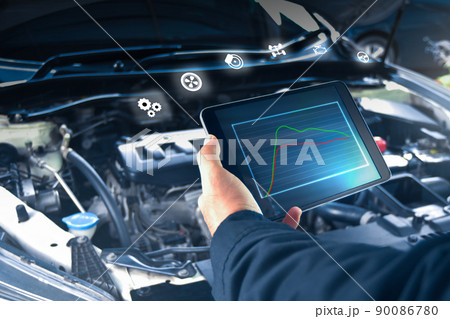 Auto mechanic is checking engine system with a ODB2 tablet and auto service icon 90086780
