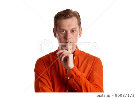 Close-up portrait of a ginger guy in orange shirt posing isolated on white background. Sincere emotions. Close-up portrait of a ginger guy in orange shirt posing isolated on white background. Sincere emotions. 90087173
