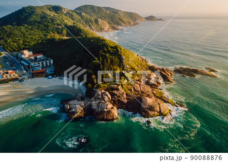 Beach with scenic coastline and ocean with waves at warm sunrise in Brazil. Aerial view Beach with scenic coastline and ocean with waves at warm sunrise in Brazil. Aerial view 90088876