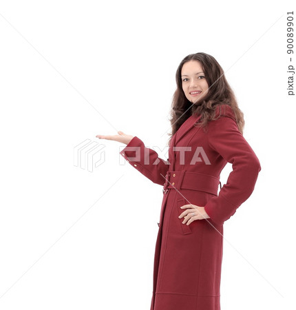 smiling young woman in red coat showing on copy space smiling young woman in red coat showing on copy space 90089901