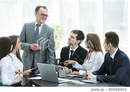 senior businessman discussing with business team to work issues senior businessman discussing with business team to work issues 90089903