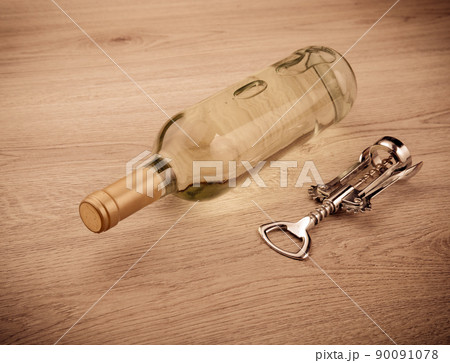 Wine bottle with corkscrew on wooden background Wine bottle with corkscrew on wooden background 90091078