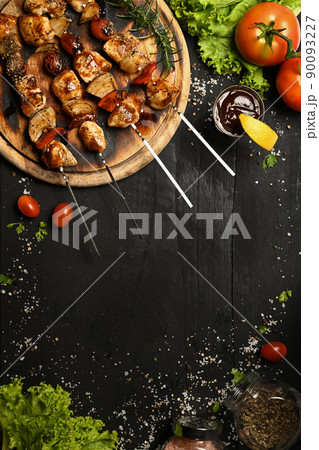 Delicious barbecue skewers with fresh vegetables on black rustic wooden table Delicious barbecue skewers with fresh vegetables on black rustic wooden table 90093227