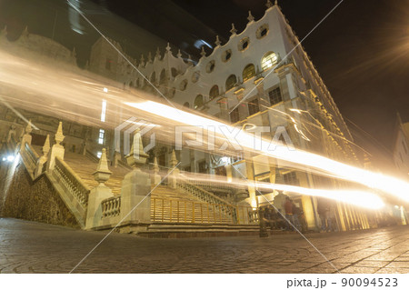 Night streets with car lights trails in City of Guanajuato, Mexico 90094523