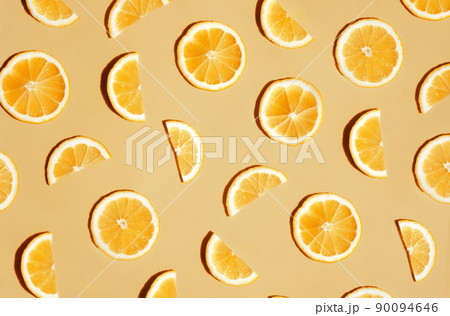 Pattern of many sliced lemons and oranges on a trendy bright yellow background. Flat lay, top view. Summer freshness, detox, antioxidants, healthy lifestyle concept Pattern of many sliced lemons and oranges on a trendy bright yellow background. Flat lay, top view. Summer freshness, detox, antioxidants, healthy lifestyle concept 90094646