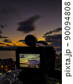 Picture of camera shooting a sunset 90094808