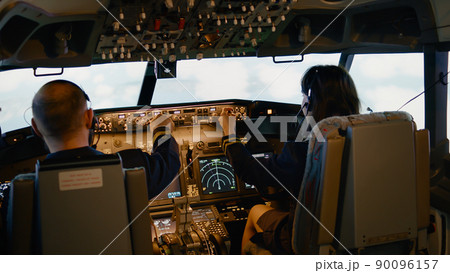 Team of aviators throttling power engine and fixing altitude level, preparing to takeoff and fly airplane. Using dashboard plane command with control panel and navigation. Handheld shot. 90096157