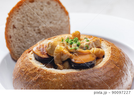 stew with pork meat, chickpeas and sausge in loaf of bread 90097227