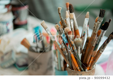 Tools of the artist-restorer, in the jars there are brushes of different sizes 90099432