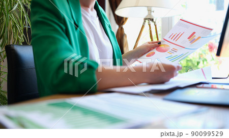 Businesswoman studies analytical business charts in office 90099529