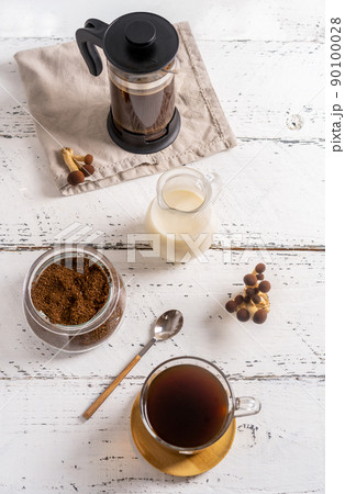 Healthy trendy coffee with mushrooms in cup, coffee pot, milk on white wooden background Healthy trendy coffee with mushrooms in cup, coffee pot, milk on white wooden background 90100028