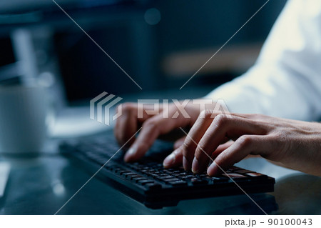 person typing text on a computer keyboard . person typing text on a computer keyboard . 90100043