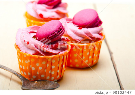 pink berry cream cupcake with macaroon on top 90102447
