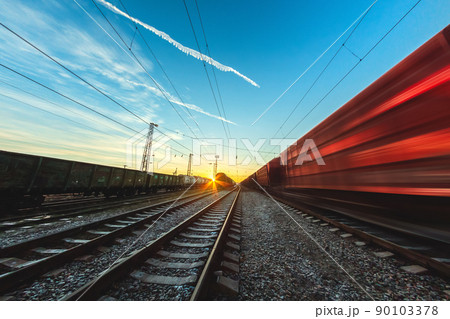 High-speed train moves by rail, delivery of goods by freight train. Train carriages at the station High-speed train moves by rail, delivery of goods by freight train. Train carriages at the station 90103378