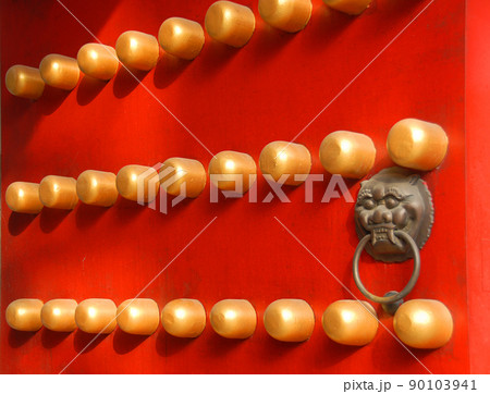 Detail of a traditional Chinese door at the Xiaoling Mausoleum of Ming Dynasty in Nanjing, Jiangsu Province, China. Red door with lion handle. Detail of a traditional Chinese door at the Xiaoling Mausoleum of Ming Dynasty in Nanjing, Jiangsu Province, China. Red door with lion handle. 90103941