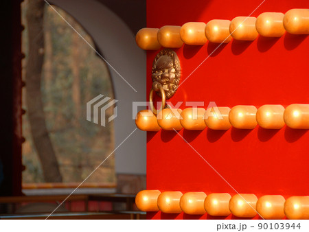Detail of a traditional Chinese door at the Xiaoling Mausoleum of Ming Dynasty in Nanjing, Jiangsu Province, China. Red door with lion handle. Detail of a traditional Chinese door at the Xiaoling Mausoleum of Ming Dynasty in Nanjing, Jiangsu Province, China. Red door with lion handle. 90103944