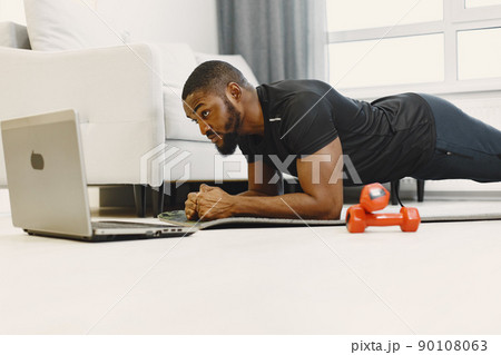 Man in a isolations. Guy training online. Man using a laptop. Man in a isolations. Guy training online. Man using a laptop. 90108063