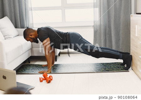 Man in a isolations. Guy training online. Man using a laptop. Man in a isolations. Guy training online. Man using a laptop. 90108064