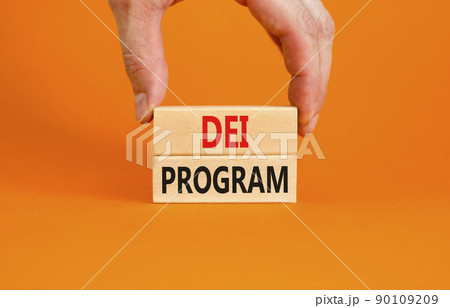DEI diversity equity inclusion program symbol. Blocks with words DEI program on beautiful orange background. Business DEI diversity equity inclusion program concept. Copy space. 90109209