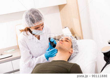 Man getting face ultrasound lifting procedure Man getting face ultrasound lifting procedure 90111886