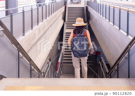Woman passenger walking on staircase at train station,Transport insurance concept Woman passenger walking on staircase at train station,Transport insurance concept 90112820