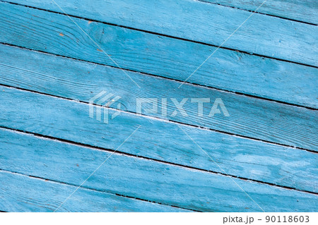 Wood texture with blue flaked paint. Peeling paint on weathered wood Wood texture with blue flaked paint. Peeling paint on weathered wood 90118603