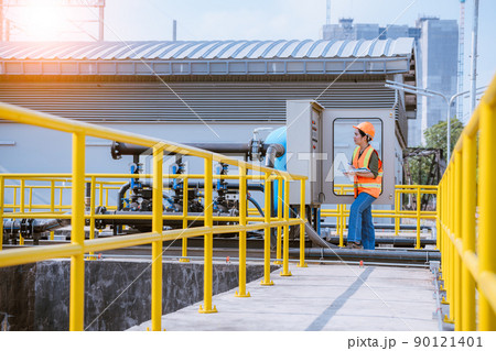 Worker under checking the  waste water treatment pond industry large to control water support industry  90121401