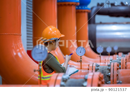 Industry engineer under checking the industry cooling tower air conditioner is water cooling tower air chiller HVAC of large industrial building to control air system. 90121537