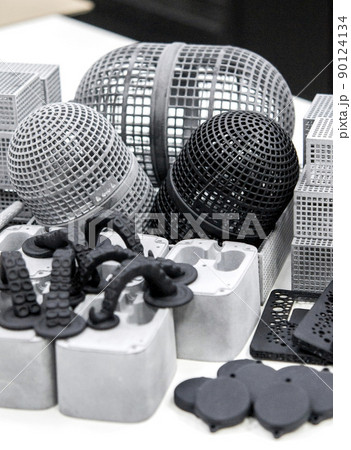 Many different objects printed on 3D printer from powder polyamide. Models printed on industrial 3D printer. Modern new prototyping technology. Additive automation manufacturing 3D printing technology Many different objects printed on 3D printer from powder polyamide. Models printed on industrial 3D printer. Modern new prototyping technology. Additive automation manufacturing 3D printing technology 90124134
