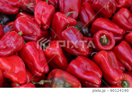 New crop of juicy red sweet peppers on market closeup New crop of juicy red sweet peppers on market closeup 90124190